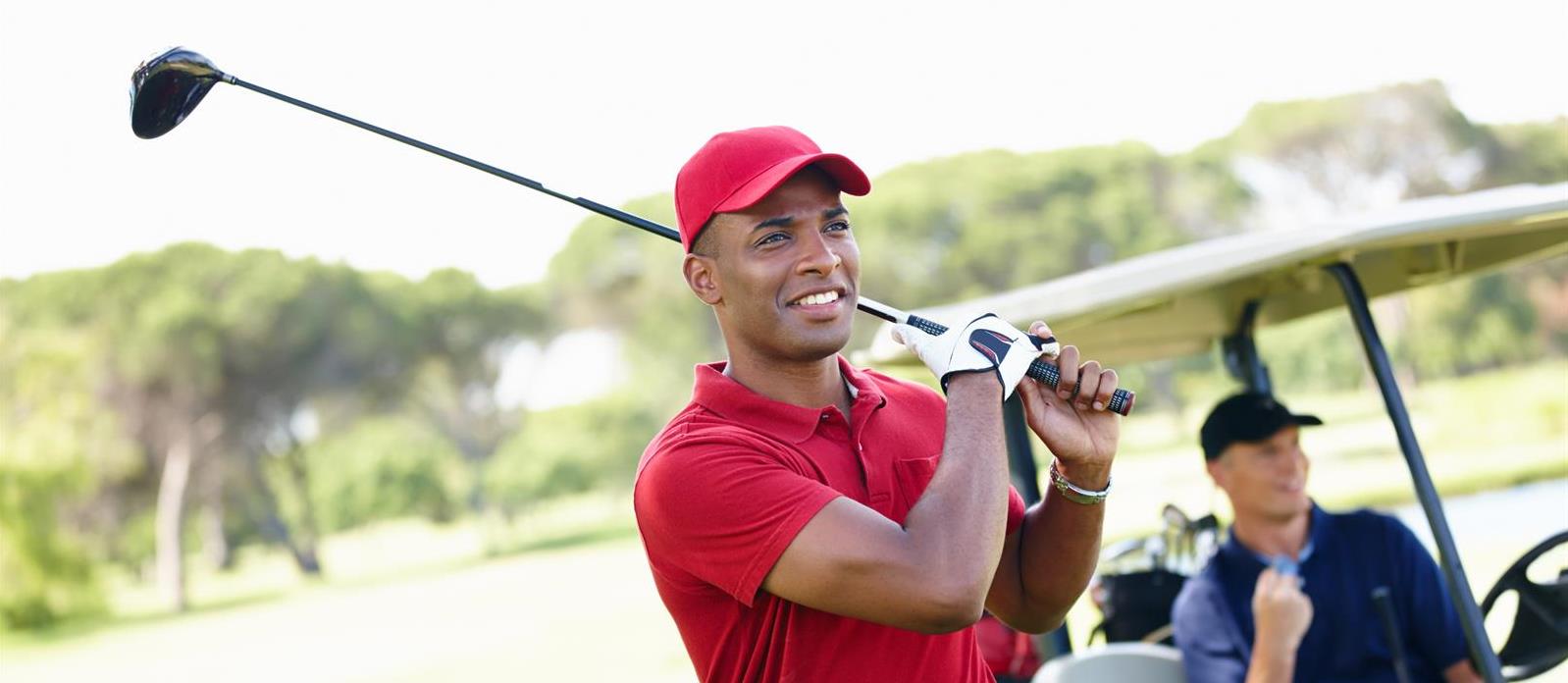 that-was-good-one-shot-young-man-taking-shot-while-his-friend-congratulates-him-from-golf-cart-background